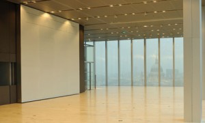 large open hallway with glass windows overlooking city skyline